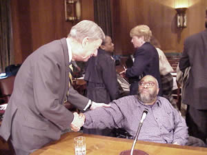 Photo of Senator Roth shaking Larry Henderson's hand at the Senate Hearing