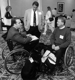 photo of three men talking between sessions at a conference