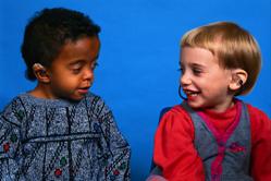 Photo of two children with hearing aids