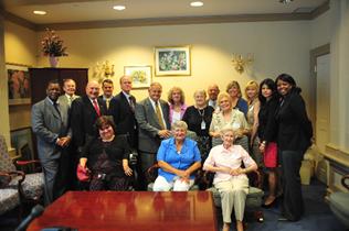 Photo of a group of people who were involved in the Gold Alert legislation. There are fourteen people standing and three sitting, including Governor Ruth Ann Minner.