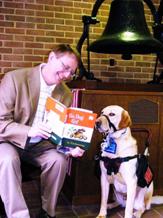 photo of Tim and Painter sitting together reading 'Go Dog Go!.'